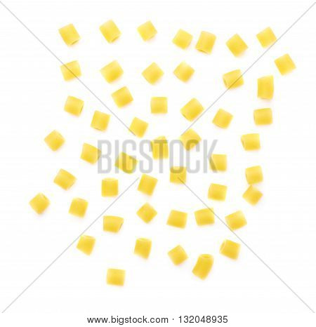 Single pieces of dry ditalini yellow pasta over isolated white background