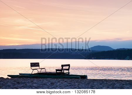 Abandoned Old Rusty Pedal Boat Stuck On Sand Of Beach. Wavy Water Level, Island On Horizon. Autumn S