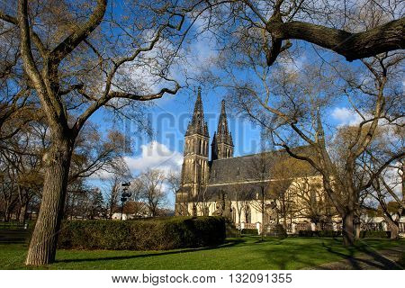 Medieval church cloudless day in Prague, view from the park