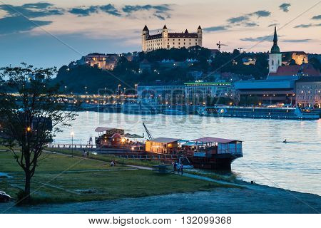 Bratislava, Slovakia - May 29, 2016
River Danube crossing the city Bratislava in the light of the sunset. View on the old city with the historical cathedral and the castle on the the hill.