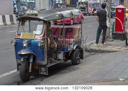 BANGKOK THAILAND - APR 30 : tuktuk parking on sidewalk of siam square on april 30 2016 thailand. tuktuk is popular taxi service of tourists in bangkok