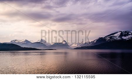Misty Norwegian costal landscape with mountains on the horizon