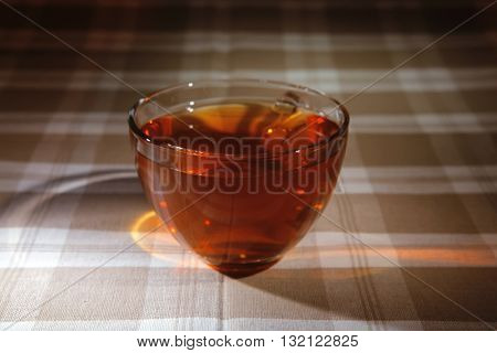 cream cheese schnitt layer cake with tea and red fresh sweet grapes on wood background