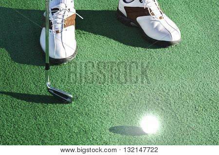 white golf ball on the green field