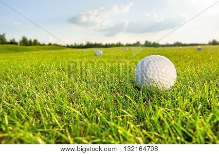 white golf ball on the green field