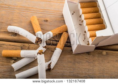 Quit Smoking - Broken Unsmoked Cigarettes Next To A Plain White Pack