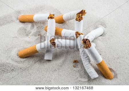 Quit Smoking - Broken Unsmoked Cigarettes In Sand