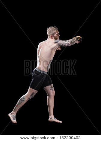 Young MMA fighter training on black background
