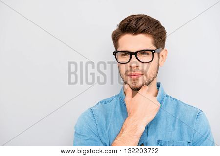 Young Calm Guy In Glasses Dreaming And Touching Chin