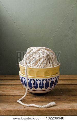 White rope in stuck bowls over retro background
