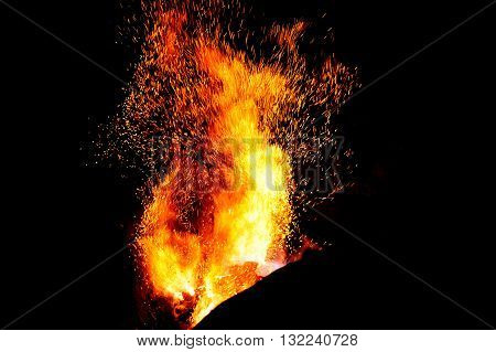 smithy fire flame tips with sparks closeup on dark background
