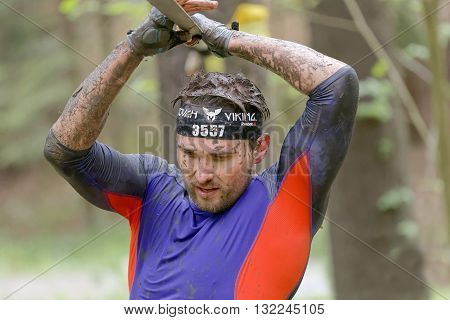 STOCKHOLM SWEDEN - MAY 14 2016: Man trying to maintain his balance on a slack rope in the obstacle race Tough Viking Event in Sweden April 14 2016