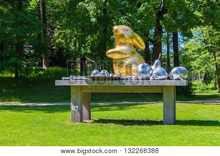 Riga Latvia - 25-May-2016: Art still life of artists Brigita Zelca-Aispure and Sandis Aispurs - sculpture of hare and fruits in Botanical Garden. Riga Latvia