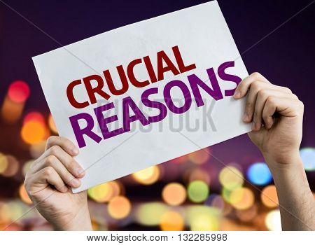 Crucial Reasons placard with night lights on background