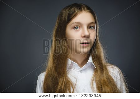 Closeup Portrait of happy girl going surprise isolated on gray background.