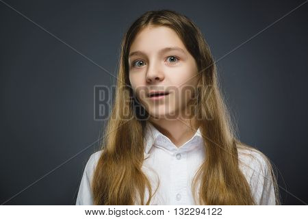 Closeup Portrait of happy girl going surprise isolated on gray background.