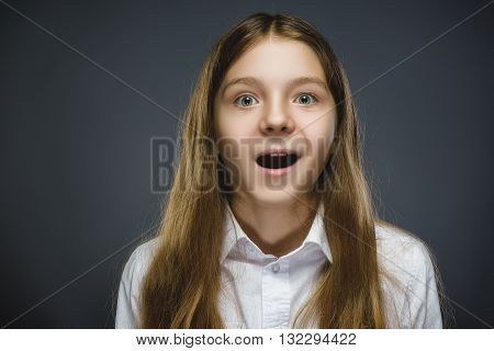Closeup Portrait of happy girl going surprise isolated on gray background.