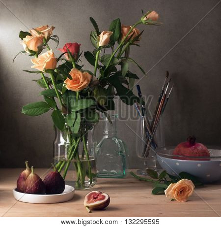 Still life with roses and figs over wooden table