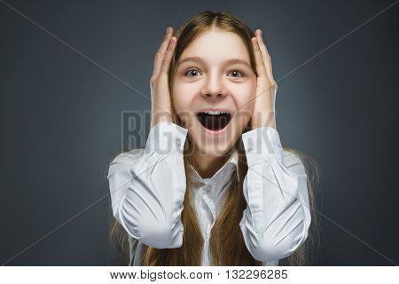 Closeup Portrait of happy girl going surprise isolated on gray background.