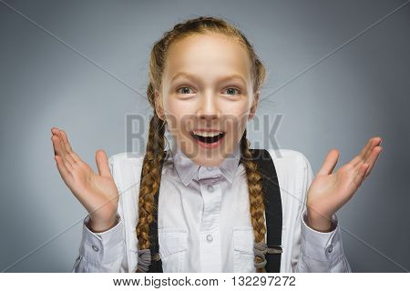 Closeup Portrait of happy girl going surprise isolated on gray background.