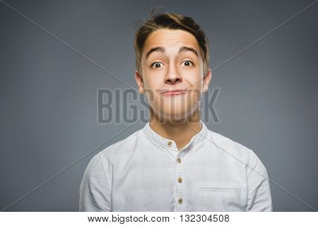 Closeup Portrait of happy boy going surprise isolated on gray background.