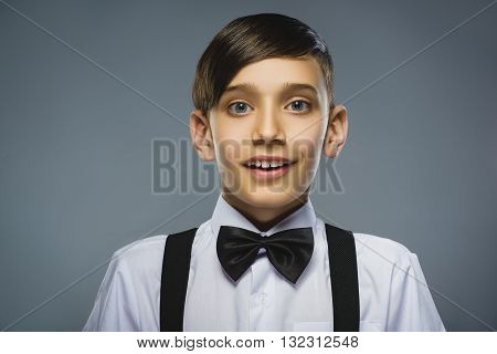 Closeup Portrait of happy boy going surprise isolated on gray background.