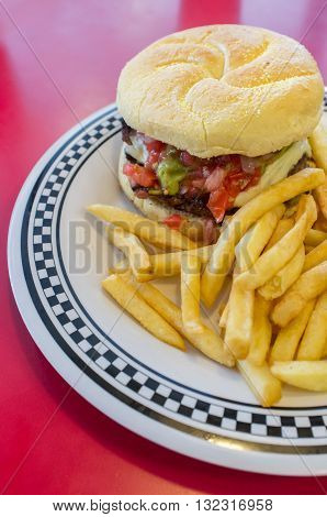 Cheeseburger on a kaiser roll with steak fries on the side