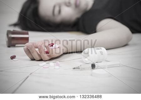 Focus on hand women after eaten pills overdose.