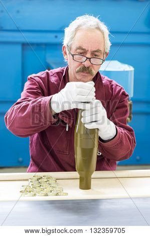 Worker At An Assembly Line In Munition Factory