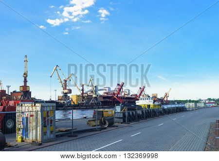 Dry Cargo Vessel And Loading Cranes At Marina In Ventspils