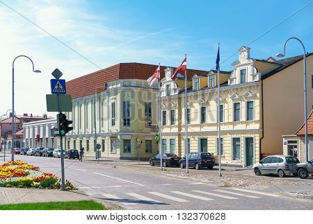 Old Yellow Building With Flags In Ventspils