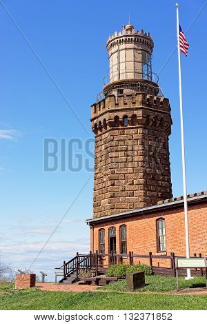 Light House And Flag At Sandy Hook In New Jersey