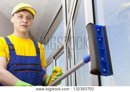 Professional cleaning, man washes window