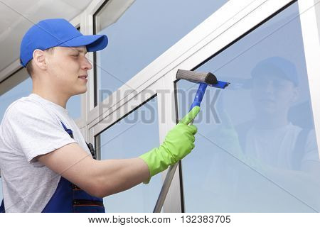 Professional cleaning, man washes window