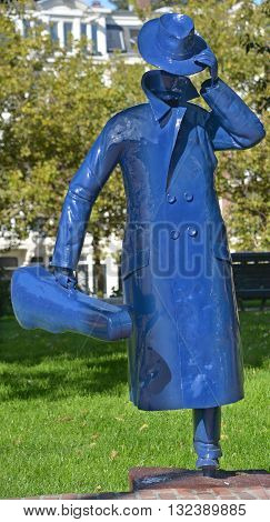 AMSTERDAM NETHERLAND OCTOBER 03 2015: The Sculpture Running man with violin case or the Invisible Man in the street Tweede Marnixplantsoen.in the Amsterdam Marnixstraat is made by an anonymous artist.