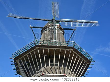 AMSTERDAM NETHERLANDS OCTOBER 01 2015: Nestled on the water at Zeeburgerdijk swings the huge blades of Amsterdam only windmill. But next door is the organic craft brew centre, Brouwerij 't IJ