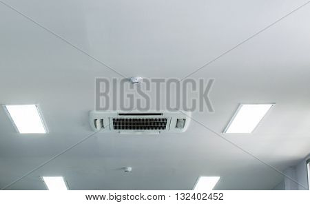 Smoke detector on white office ceiling.Office Ceiling Plastic White.