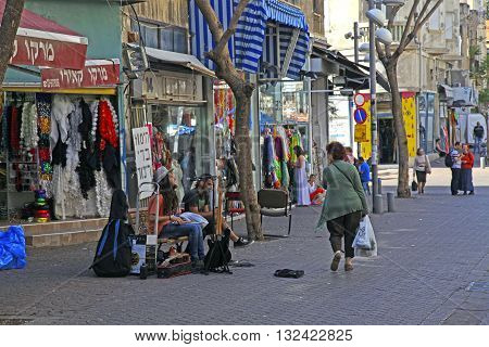 TEL AVIV, ISRAEL - APRIL 3, 2016: People and street musicians at old Nahalat Binyamin district, Tel Aviv, Israel.