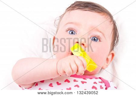 Image of a baby girl with rattle teether toy.