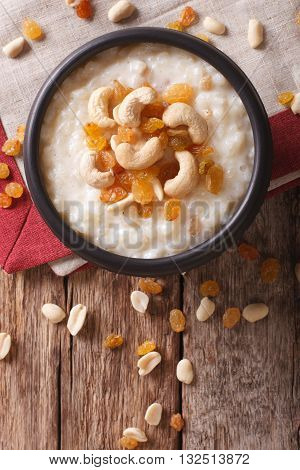 Tasty Rice Pudding With Nuts And Raisins Close-up. Vertical Top View