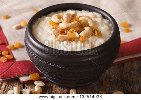Tasty Rice Pudding With Nuts And Raisins In A Bowl Close-up. Horizontal