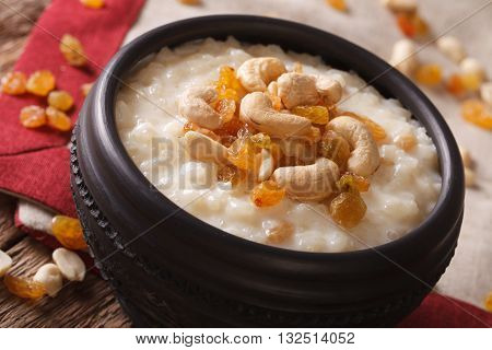 Rice Pudding With Nuts And Raisins In A Bowl Close-up. Horizontal