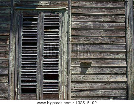 Details of an old weathered abandoned western colonial style wooden house shed