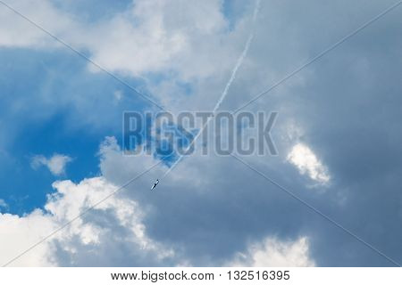 Jet plane flying down to the ground by releasing a stream of smoke