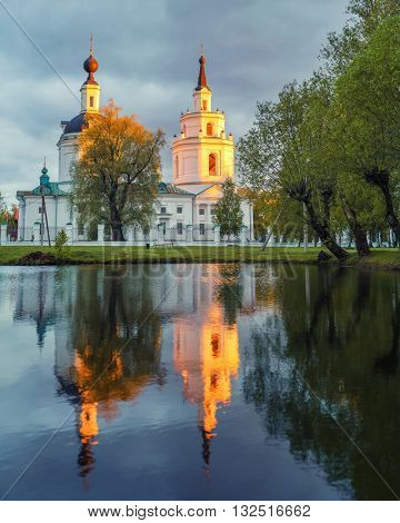 Russian orthodox church and its reflection in a pond. Boldino, Russia