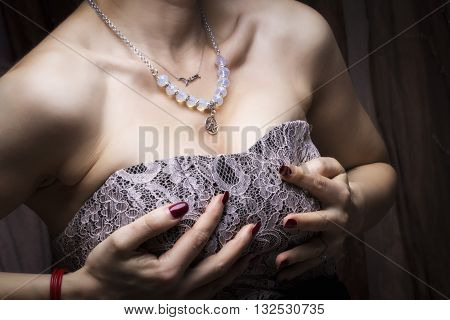 young girl with hands on their large breasts 