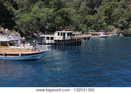 FETHIYE,TURKEY- 26TH MAY  2016 : Turkish pleasure boats on a trip with passengers in a bay near Fethiye, Turkey , 26th may 2016