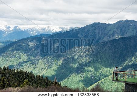 Explorer observes an outstanding panorama in the mountains.