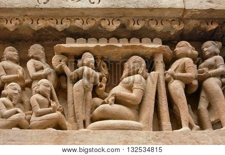 Khajuraho relief scenes with naked woman and king. Famouse artistic project on walls of historical temple in India. UNESCO Heritage site built between 950 and 1150