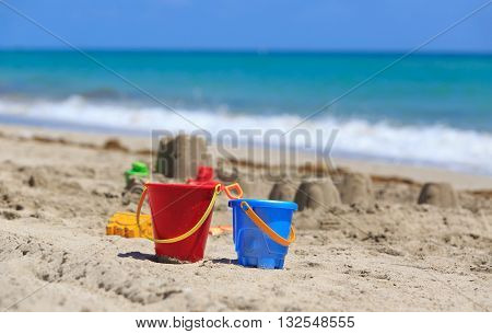 kids play on sand beach concept- toys and sandcastle